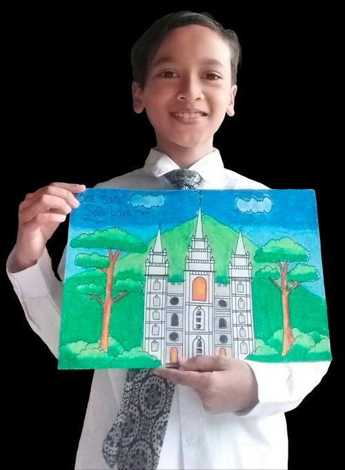 boy holding drawing of the temple