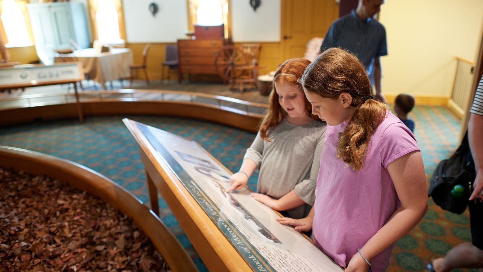 Two sisters interact with various exhibits in the Book of Mormon Historic Publication Site (E. B. Grandin's Print Shop) in Palmyra, New York.