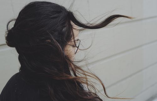 Young adult woman with wind-blown hair