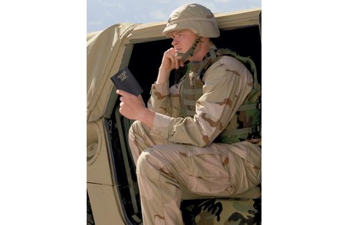 a soldier reading the Book of Mormon