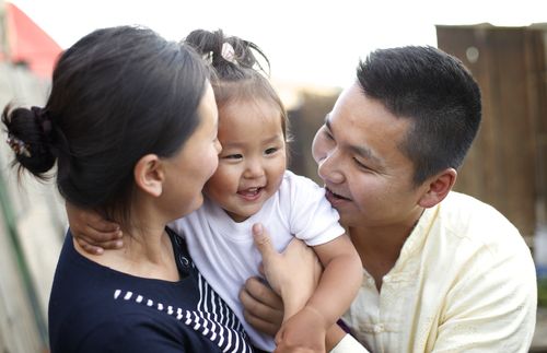 couple holding little girl