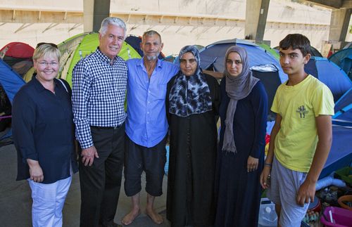President Uchtdorf and his daughter visiting refugees