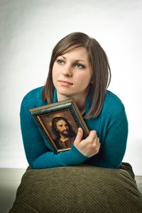 youth holding a picture of the Savior