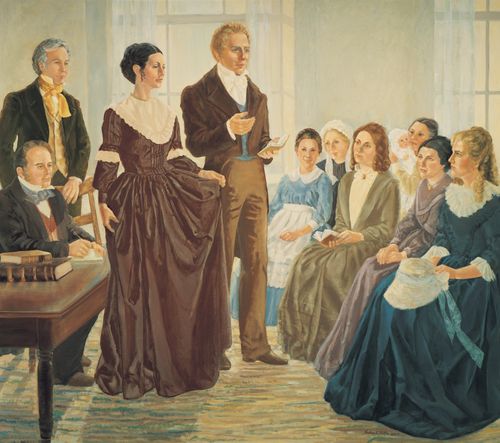 A painting by Nadine Barton of Joseph Smith Jr. and his wife Emma Smith standing before a group of sitting women as they organize the Relief Society.