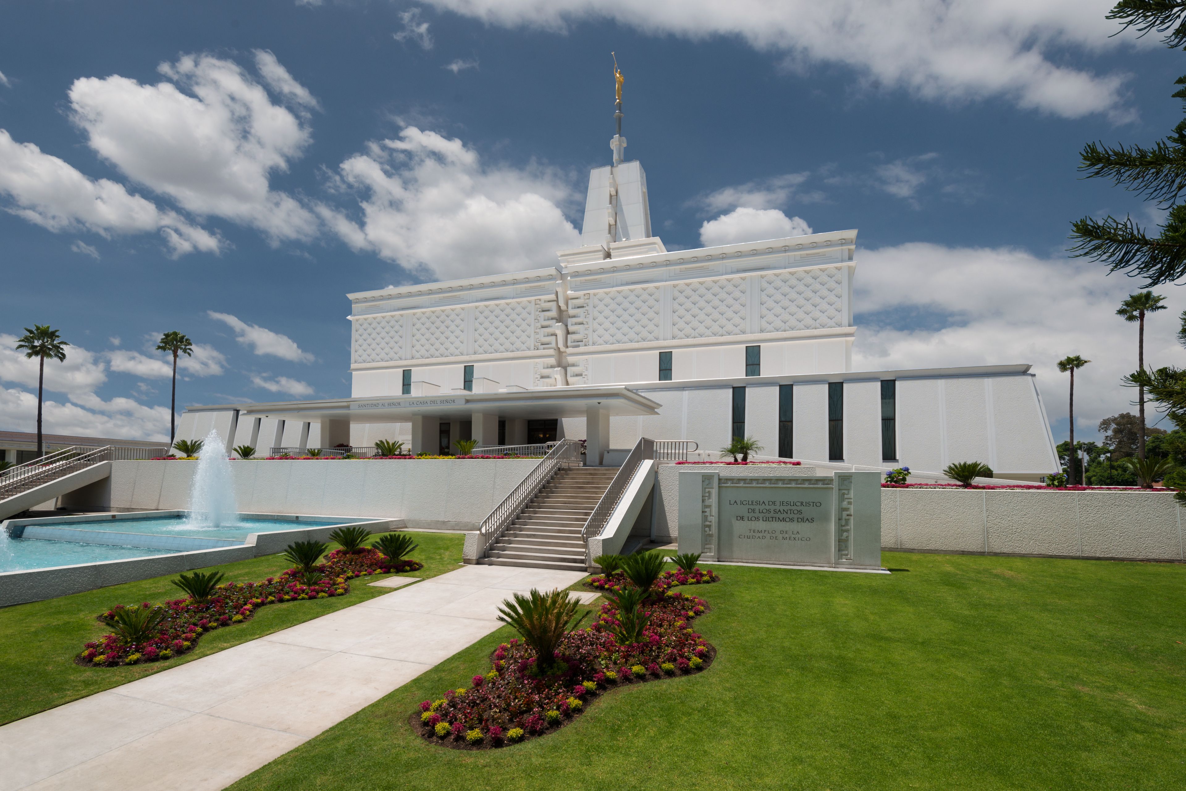The entrance of the Mexico City Mexico Temple, with green lawns and flower beds in the front.