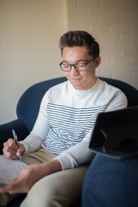 youth writing in notebook