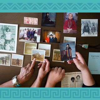 Youth and grandparent looking at family photos