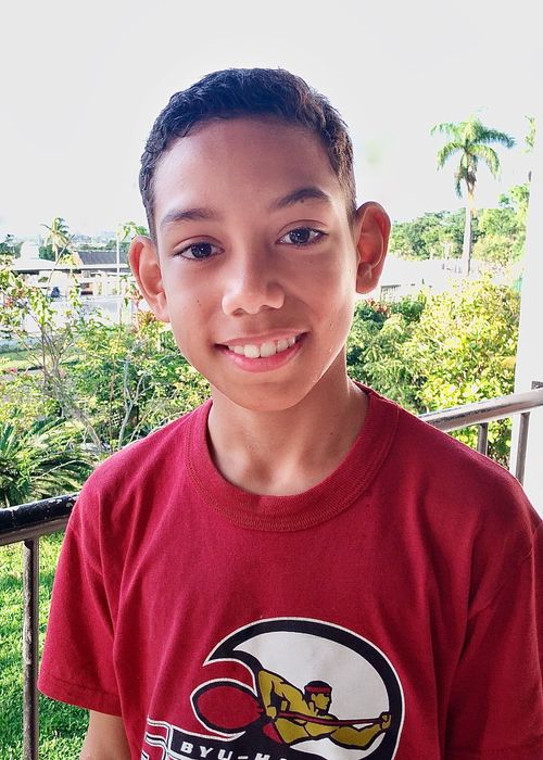 A young boy named Seth smiles as his picture is taken.