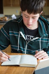 young person writing in a journal