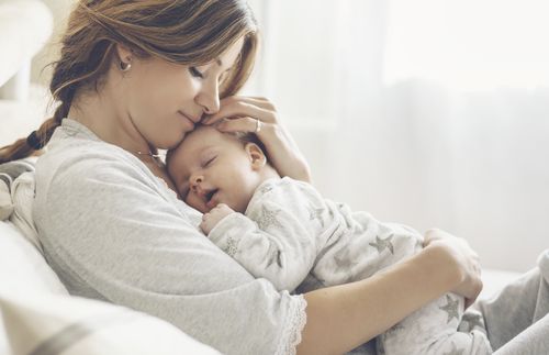 young mother holding newborn baby