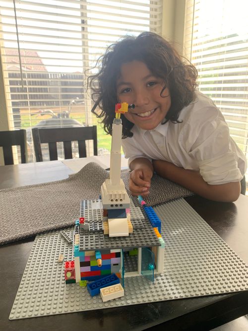 boy showing temple from building blocks