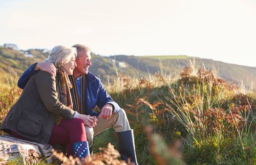 older couple sitting together outdoors