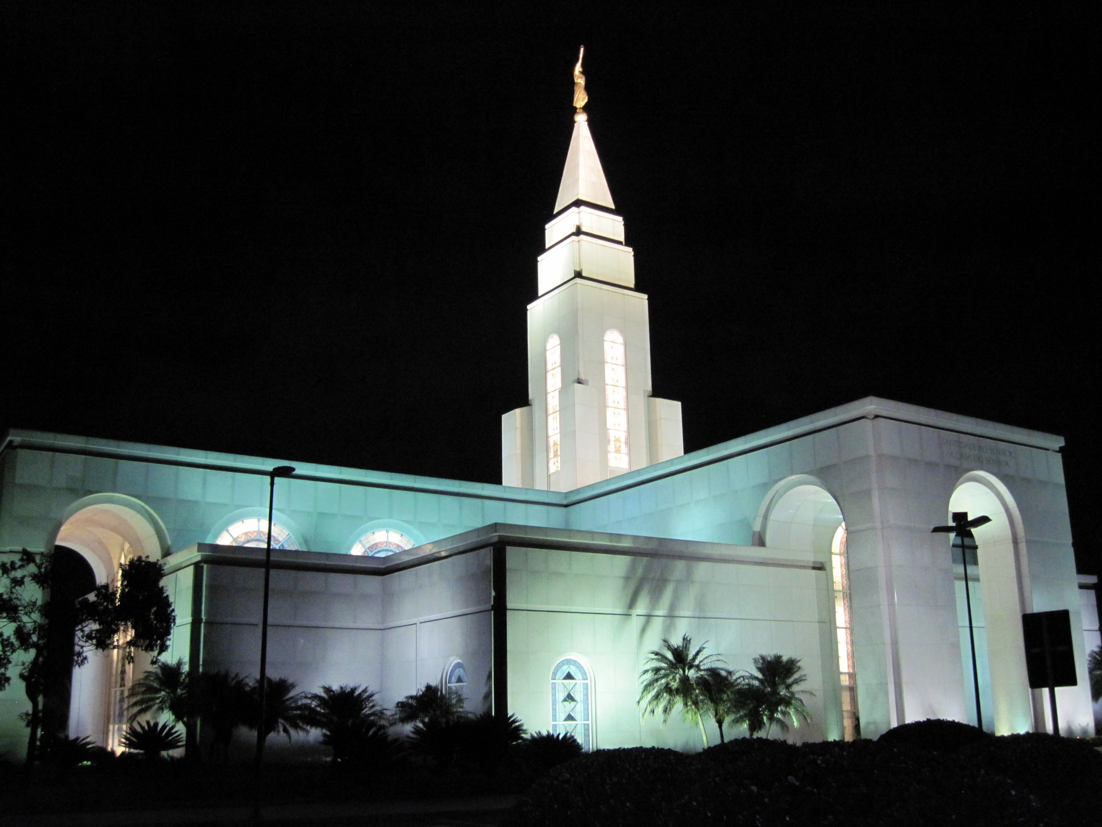 An exterior view of the Campinas Brazil Temple lit up at night.