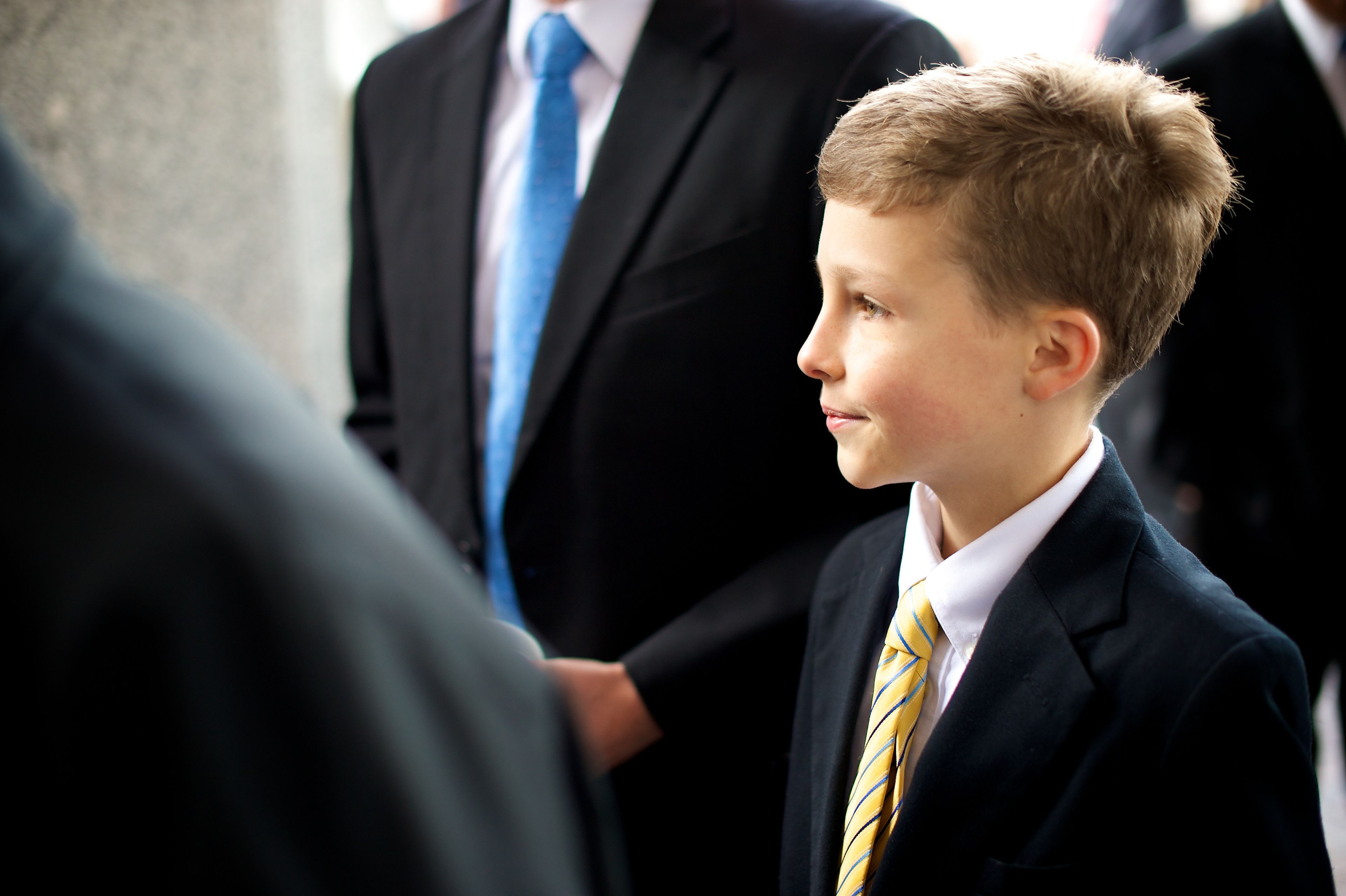 A young boy standing outside of the Conference Center before a session of general conference.