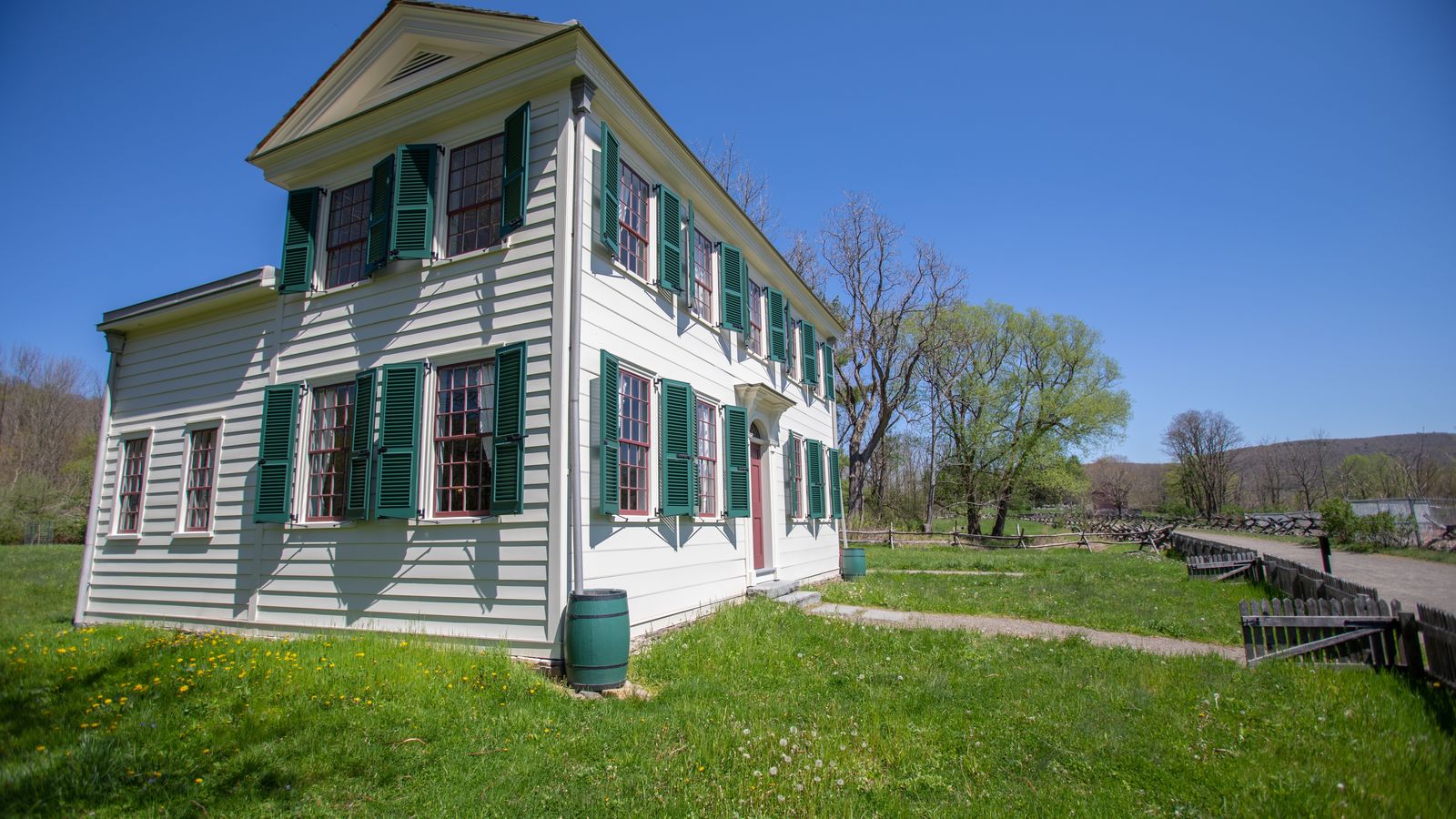 Isaac and Elizabeth Hale lived within a few miles of the village of Harmony on approximately 620 acres. On this property he built his home, his nine children were born, and he is buried. Joseph Smith, Sr., and Joseph Smith, Jr. boarded in the Hale home while they were employed by Josiah Stowell in 1825. This structure is a re-creation. This photo shows the Hale home in relation to the Smith home. Photo taken May 2022.