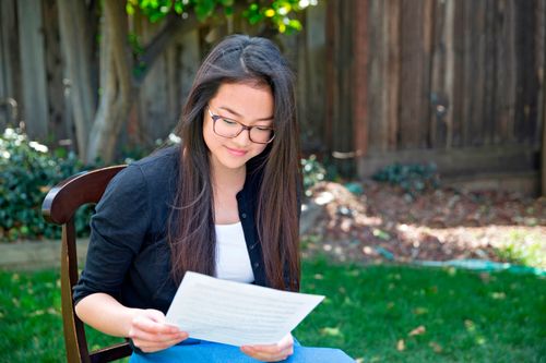 a young woman reading her patriarchal blessing