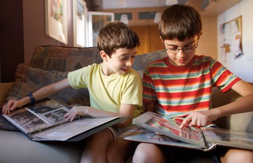 Two boys looking at family photo albums