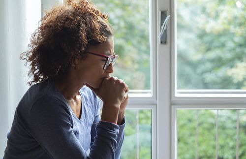 woman pondering by window