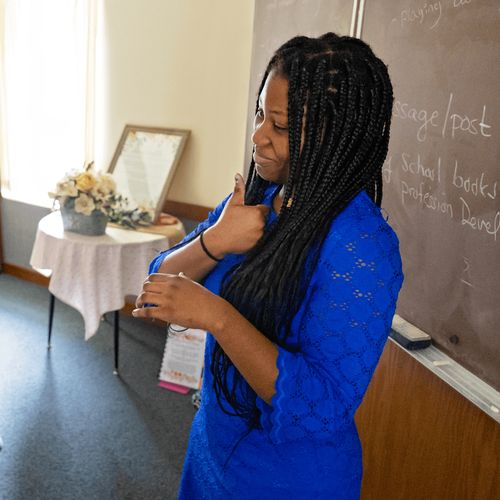 young woman teaching in church in American Sign Language