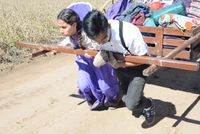 two teens pulling a handcart