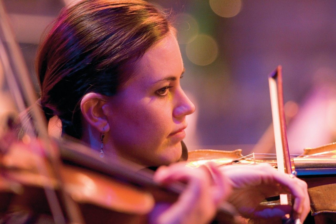 A woman plays a violin during a concert on Temple Square.