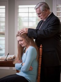 young woman receiving blessing