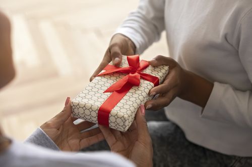 person holding Christmas gift