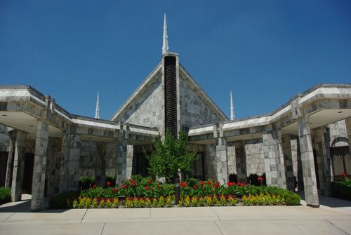 A close-up view of the entrance to the Chicago Illinois Temple, with the flower beds in full bloom.