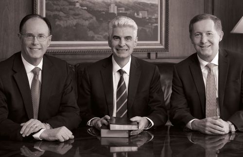 Presiding Bishopric members sitting at a table