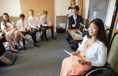 woman in wheelchair teaching a class