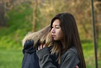 young woman being comforted by friend