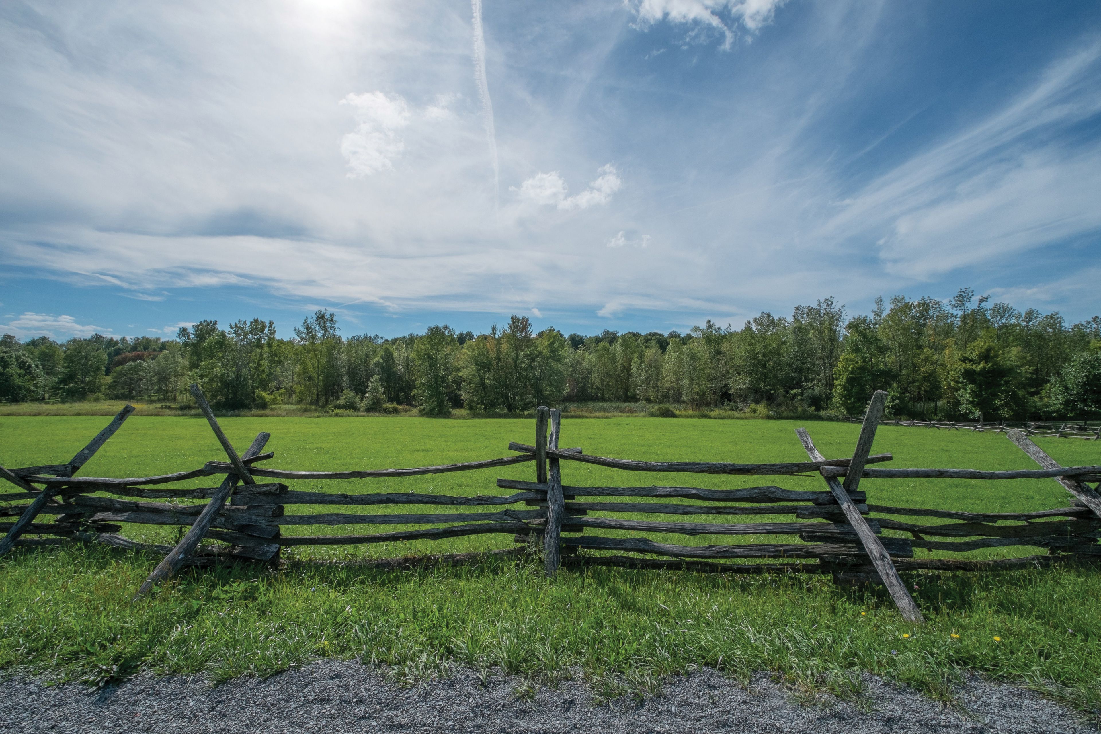 A wooden fence running the perimeter of a field on the Smith family farm in Palmyra, New York.