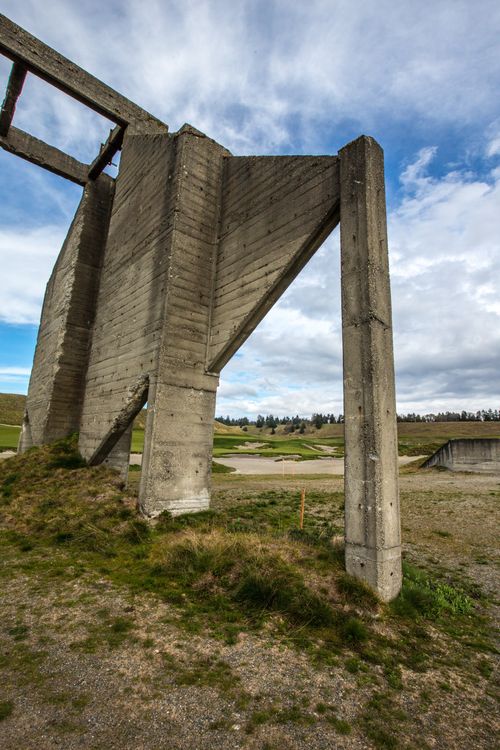 A concrete ruin on a hill in Chambers Bay in Washington, with clouds in the sky overhead.