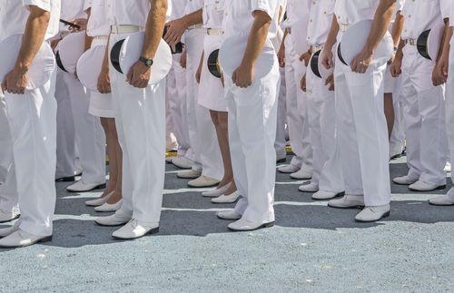 rows of navy personnel in white uniforms