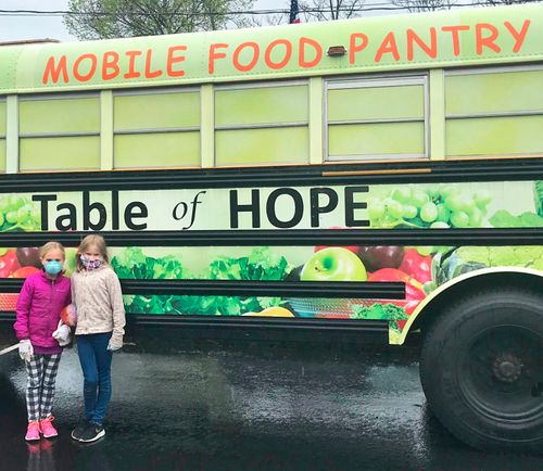 A photo of Emma - Charlotte standing in front of a bus