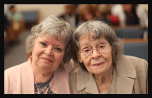 two women sitting next to each other