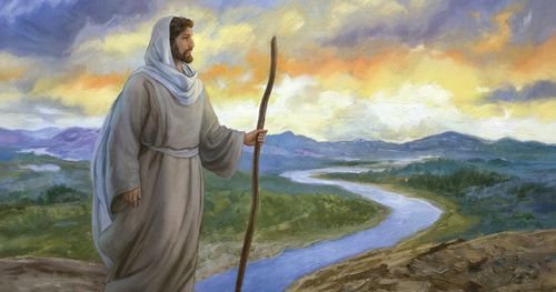 Jesus Christ is standing on a hill over looking a river.