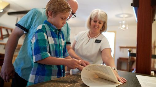 A father and son interact with various exhibits in the Book of Mormon Historic Publication Site (E. B. Grandin's Print Shop) in Palmyra, New York.