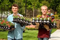 young adults holding flowers at service project