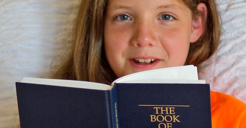 young woman reading the Book of Mormon