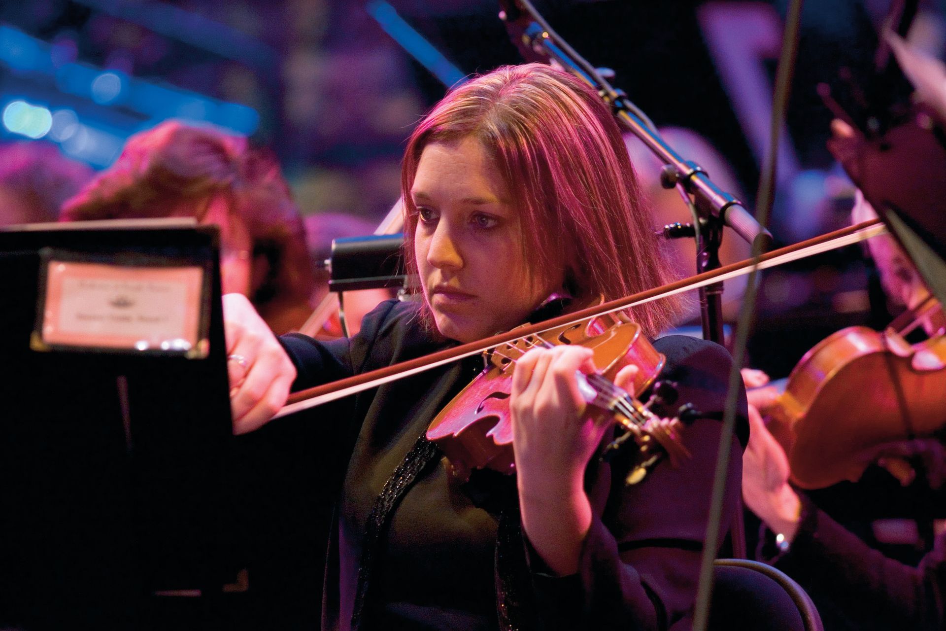 A violinist plays in the Orchestra at Temple Square during a concert.