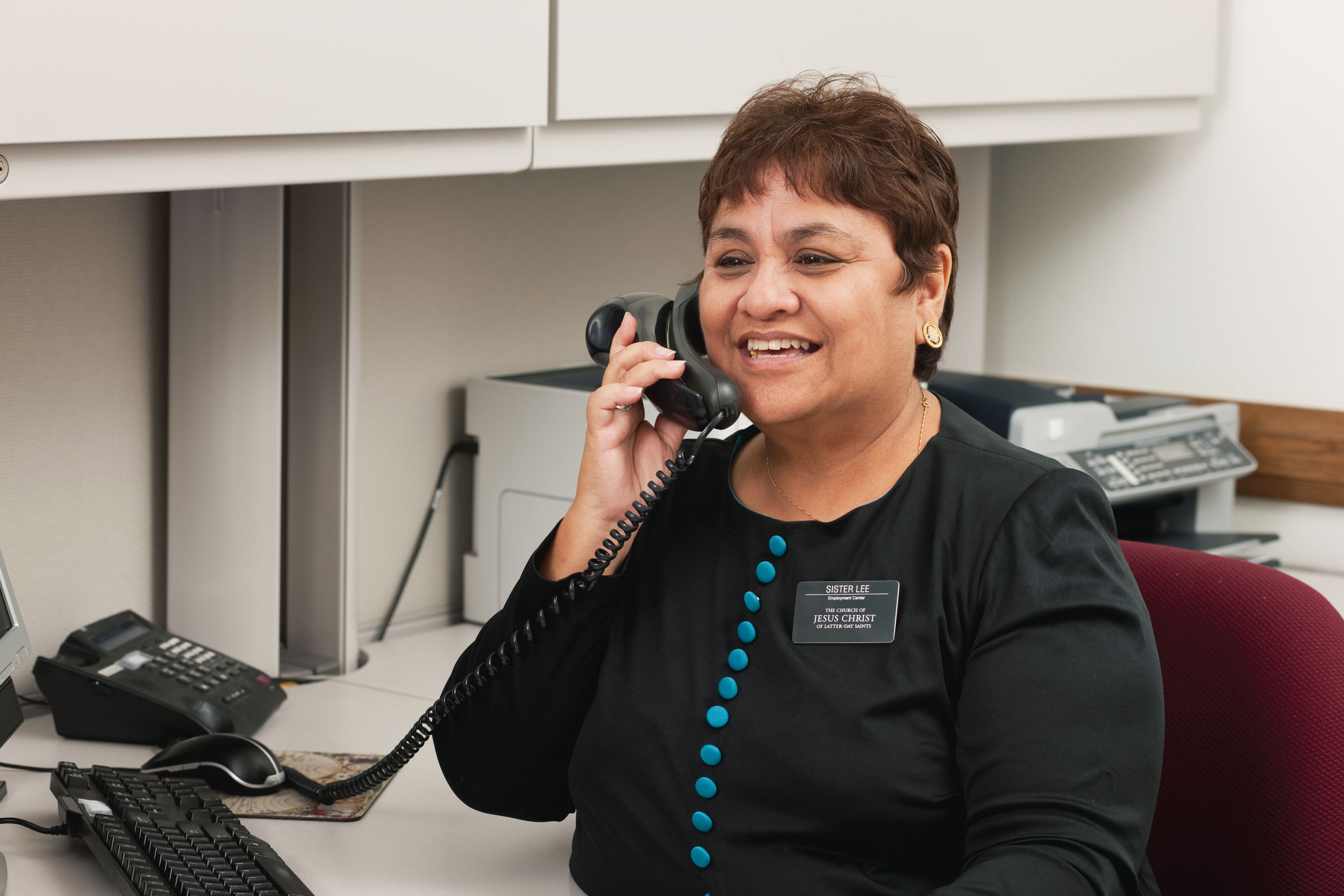 A senior sister missionary on the phone at the LDS employment resource center.