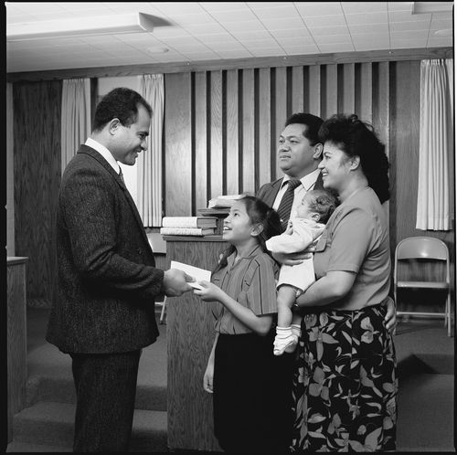 young girl paying tithing