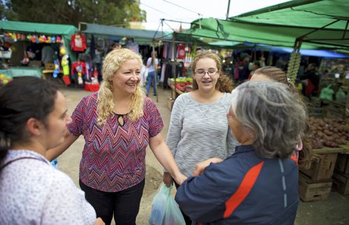 women talking at outdoor market