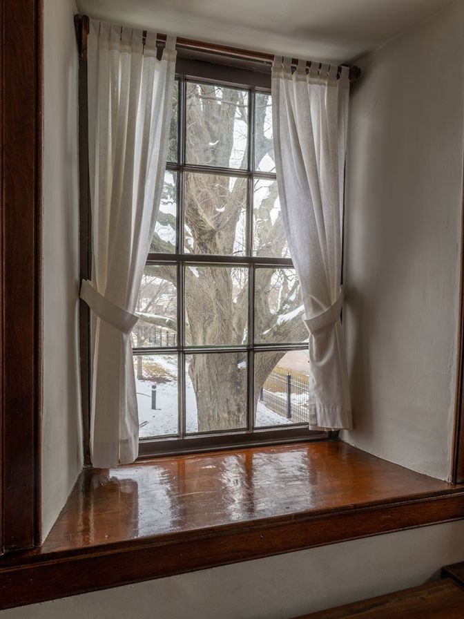 Paned window with a deep wooden sill.