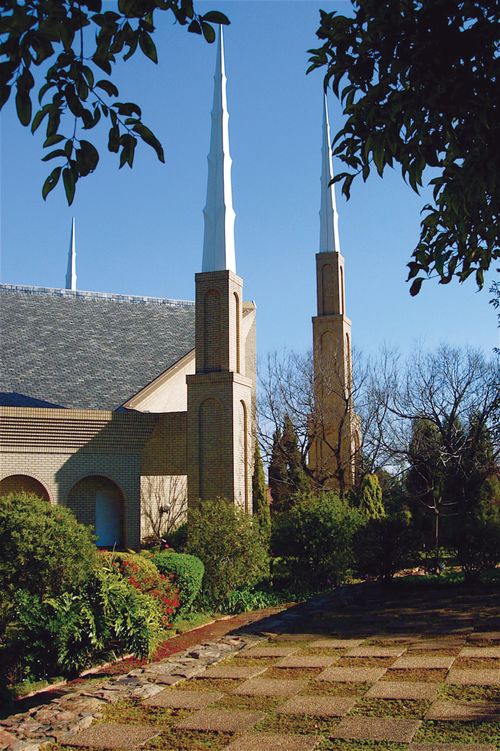 Several of the spires on the Johannesburg South Africa Temple, seen beyond a stone path leading toward the temple.