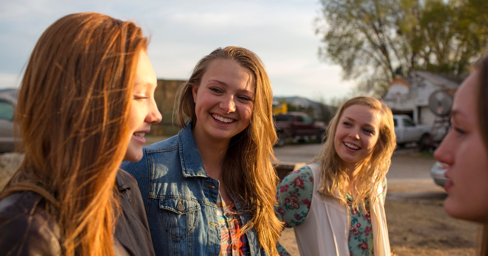 Young ladies laughing on a farm.