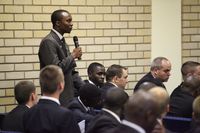 young man speaking into microphone