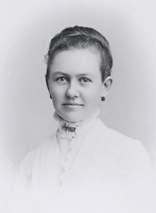 A portrait of George Albert Smith’s wife, Lucy Smith, at age 19, in a white blouse and earrings, with her hair up.
