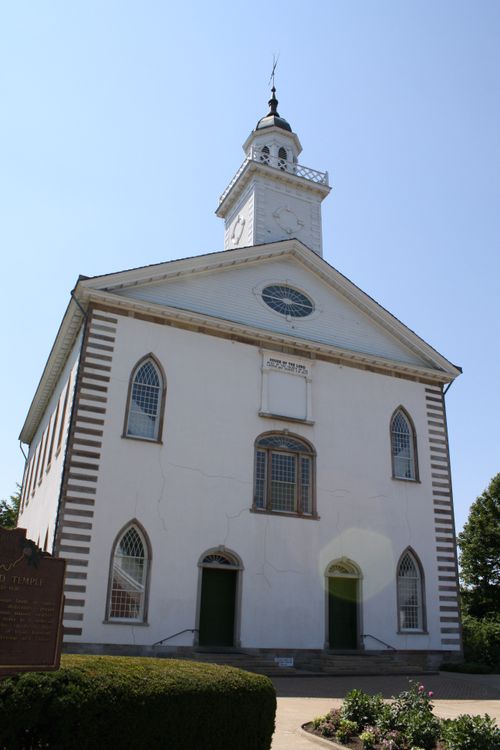 The front of the Kirtland Temple on a sunny day, viewed from below.